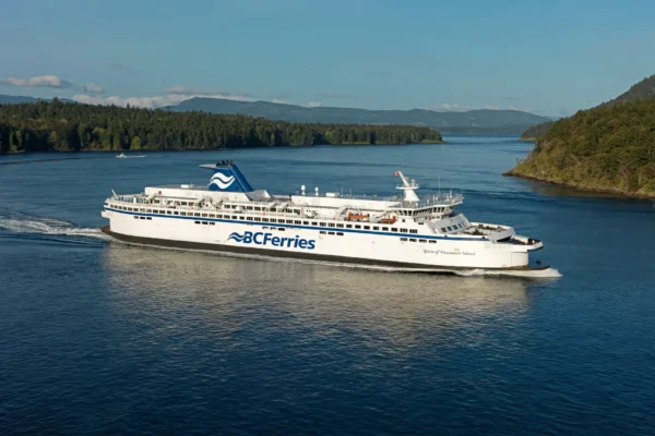 BC Ferries vessel sailing on coastal waters with forested islands