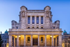 The front facade of the British Columbia Parliament Buildings in Victoria lit at dusk