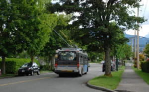 A trolleybus on a tree-lined residential street in East Vancouver