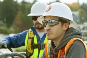 An electrician apprentice at work on a job site