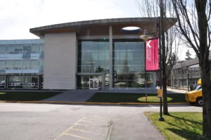Front entrance of Kwantlen Polytechnic University's Surrey campus with a red KPU banner