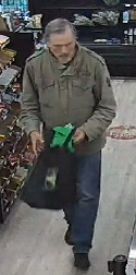 Morgan Drew wearing an olive-green jacket and carrying a bag. Photo: Ucluelet RCMP