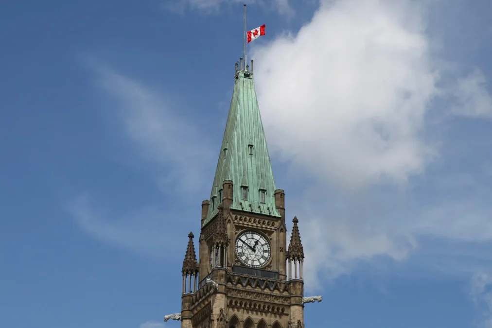 Canadian flag at half-mast above the Peace Tower clock tower in Ottawa