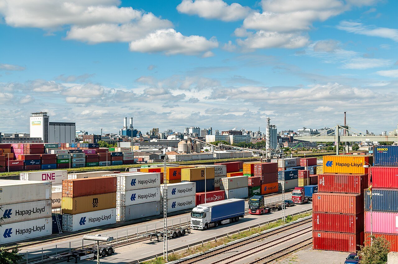 Stacked shipping containers at a cargo terminal.
